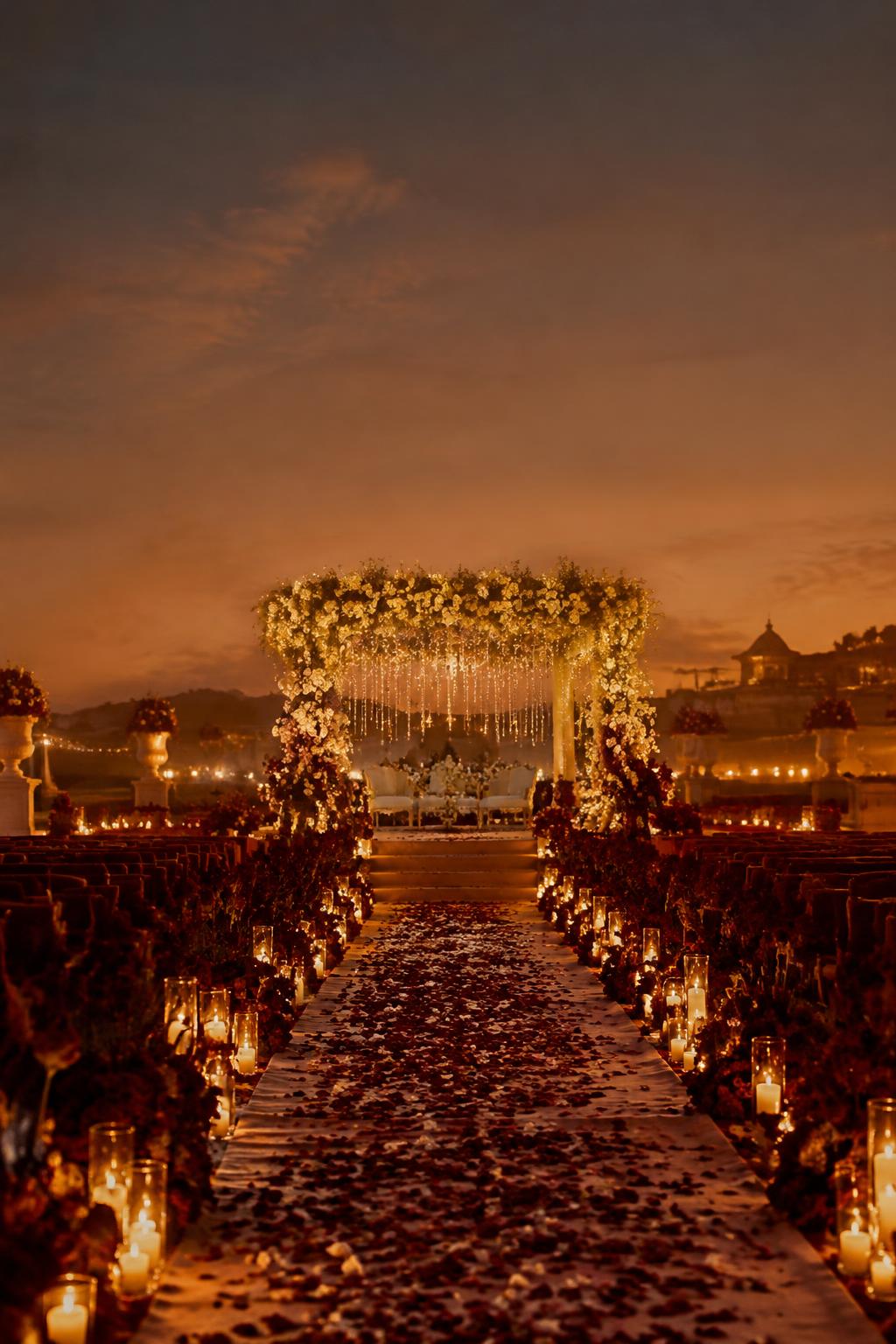 Candlelit wedding aisle at twilight